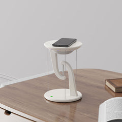 White adjustable desk lamp on a wooden desk with a gray wall background