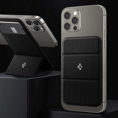 Black magnetic card holder attached to an iPhone displaying cards and phone stand function
